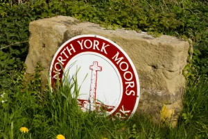 A picture of the North York Moors National Park Sign on some sandstone